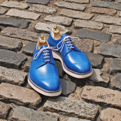 blue derby shoes with wooden trees